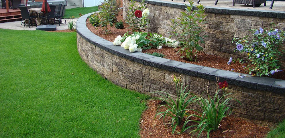 Montigny Landscaping, for Quality Landscaping Sturbridge Mass and vicinity, displays a tiered hardscape-planting combinationes and plantings