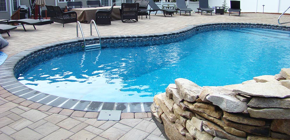 Poolside hardscapes and stone features Montigny Landscaping, for Quality Landscaping Sturbridge Mass and vicinity; this photo is from Douglas Mass.